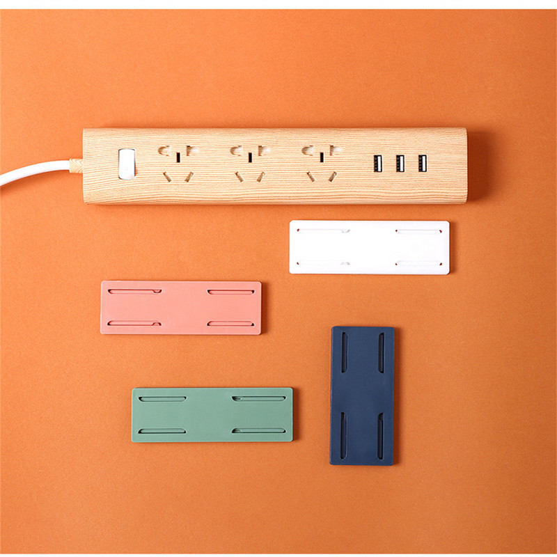 Sienā montējams kontaktdakšas fiksācijas uzlīme Bez štancēšanas mājas pašlīmējošā kontaktligzdas fiksatora kabeļa vadu organizators bezšuvju strāvas sloksnes turētājs