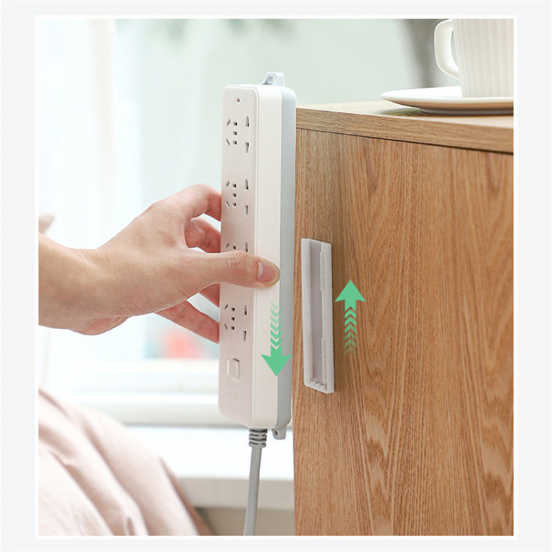 Sienā montējams kontaktdakšas fiksācijas uzlīme Bez štancēšanas mājas pašlīmējošā kontaktligzdas fiksatora kabeļa vadu organizators bezšuvju strāvas sloksnes turētājs