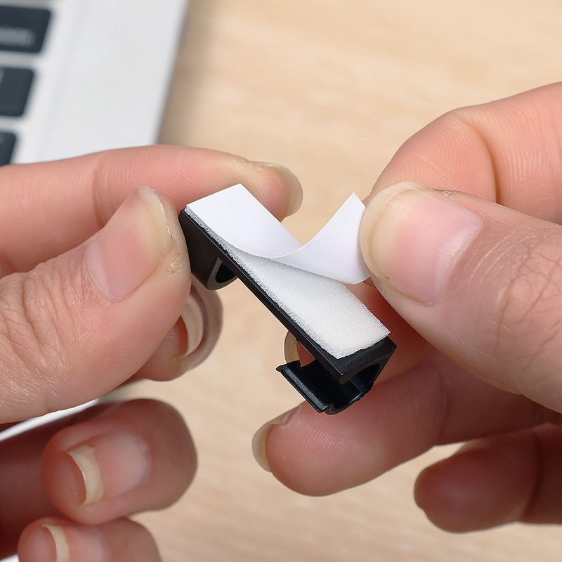 20 gab. Pašlīmējošie kabeļu skavas Mājas biroja galddatora organizators Vadu pārvaldnieks Vada turētājs Kabeļa skava austiņu līnijas uztīšanas fiksators