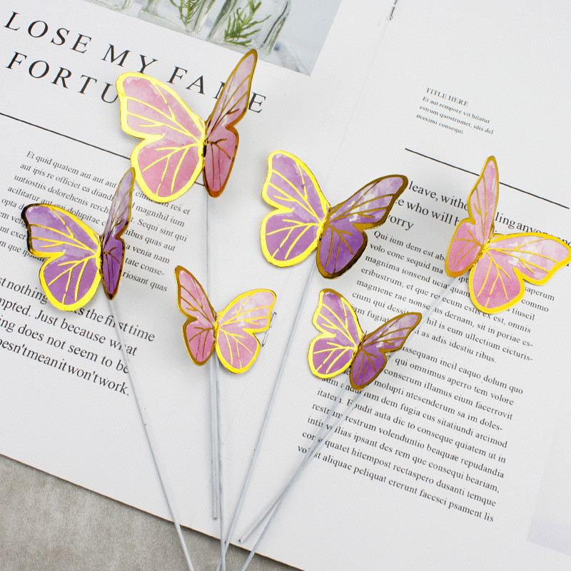 7 vnt. rožinės spalvos aukso spalvos drugelių tortų tvarsčiai su gimtadieniu.