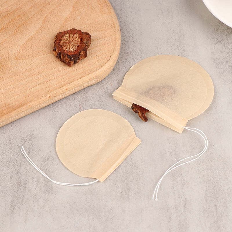 50 gab. Apaļš tējas maisiņš Tējas maisiņš papīra savilkšanas aukliņas Eko filtrs Tukšs birstošo lapu pulvera garšaugu filtrs