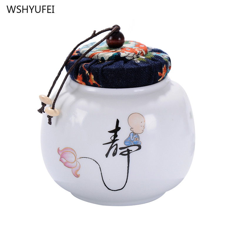 Pārnēsājamas ceļojumu matētas smērvielas, baltas keramikas, aizzīmogotas uzglabāšanas burka kafijas pupiņu tēja, konfekšu cepumi, pārklāti virtuves uzglabāšanas pudeļu kārbas