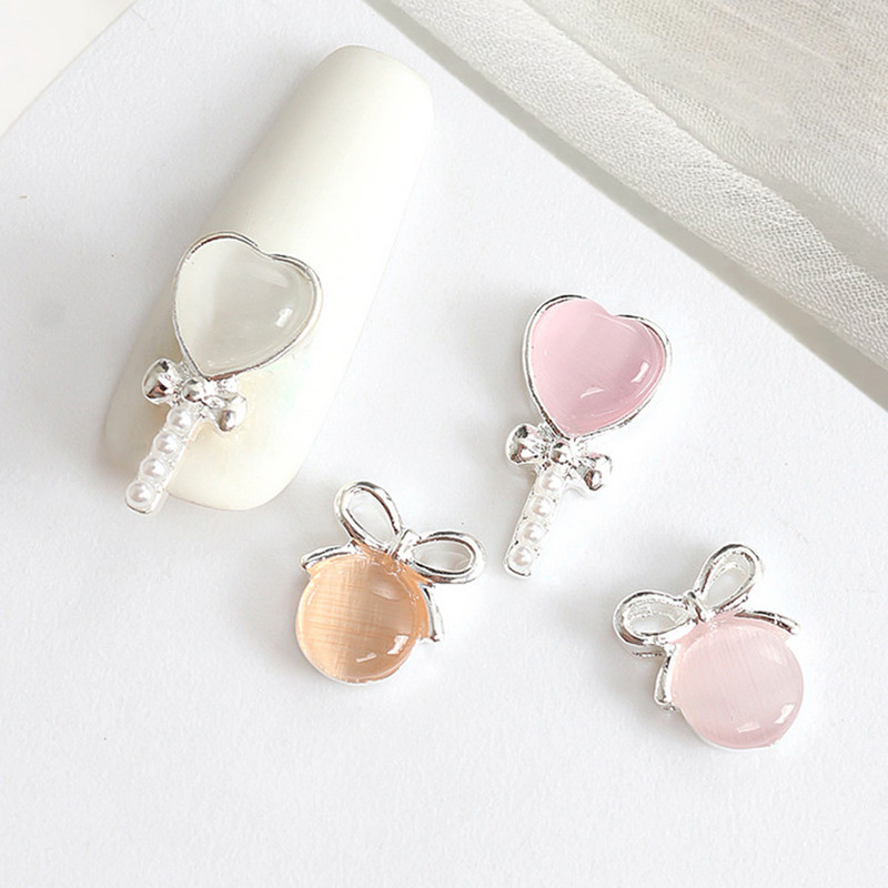 10 tk Cat's Eye Bow küünekunsti amuletid 3D sulamist kullast/hõbedast kassisilmakivist pulgakomm Garland küünekunsti kaunistus DIY küünte tarvikud