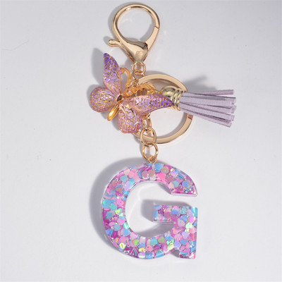 Μπρελόκ με αρχικό γράμμα για γυναίκες Φούντα πεταλούδα μωβ Χαριτωμένο μπρελόκ αυτοκινήτου για γυναικεία κοριτσίστικα πορτοφόλια στολίδια σακίδιο πλάτης