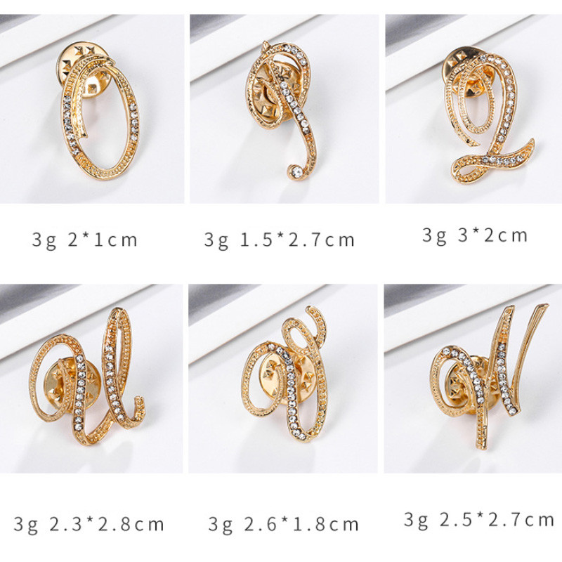 Uued Rhinestone`i kristallist prossid kullavärvi 26 inglise kirjaga revääridega särk Kleit rinnamärk Moeehted naistele Aksessuaarid