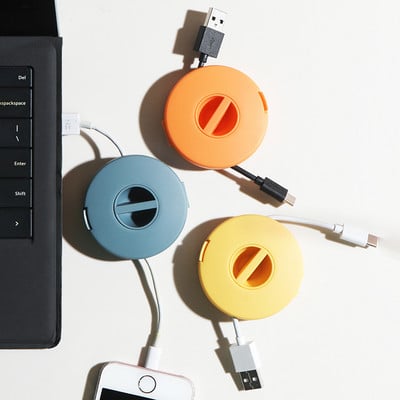 Περιστρεφόμενη στρογγυλή περιτύλιξη ακουστικών Φορτιστής καλωδίου δεδομένων κινητού τηλεφώνου Κουτί αποθήκευσης καλωδίου Αυτόματη υποδοχή καλωδίων με δυνατότητα προσαρμογής καλωδίου USB