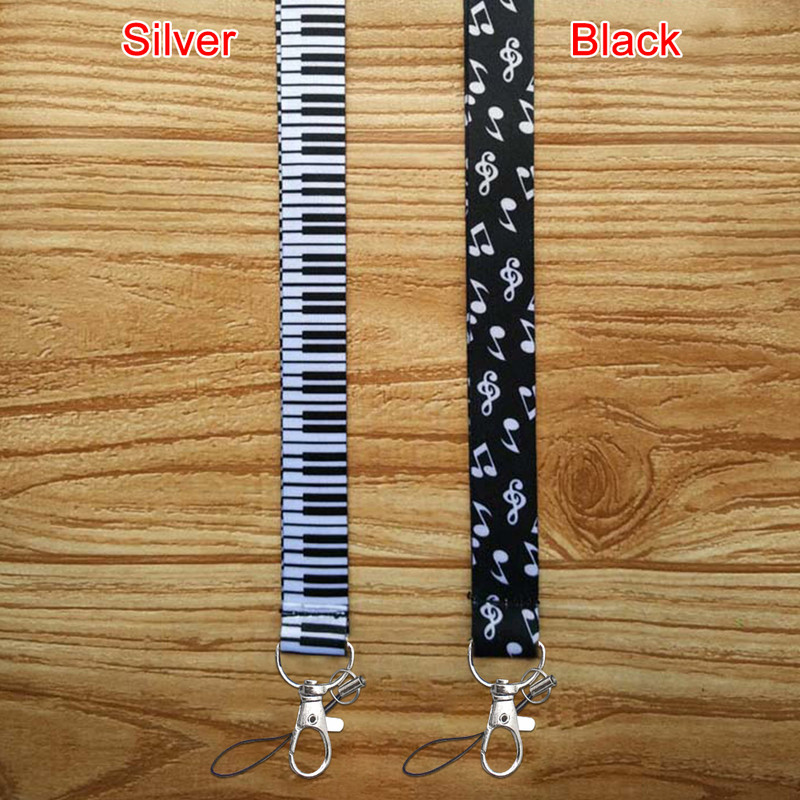 Minkšti fortepijono klavišai, patvarūs, „pasidaryk pats“ aksesuarai, rankoje laikomi pakabinami užrašai Pradžia Mobiliojo telefono dirželiai