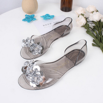 Διαφανή γυναικεία σανδάλια από PVC 2023 Καλοκαιρινή μόδα Κρυστάλλινη πούλιες Σχέδιο λουλουδιών Επίπεδα παπούτσια Γυναικεία Peep Toe Casual σανδάλια