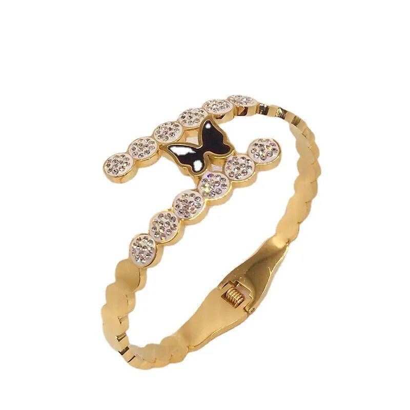 Titāna tērauda jauna modes melna tauriņa rokassprādze ar pavasara atvēršanas dizaina sieviešu nerūsējošā tērauda rokassprādzēm