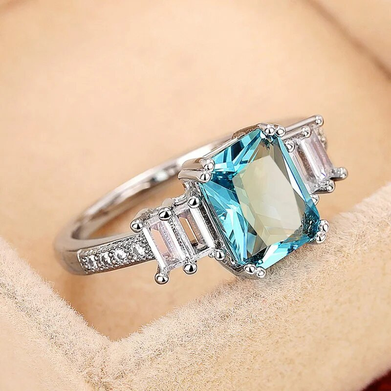 Huitan Eleganti taisnstūrveida zils CZ sieviešu gredzeni Iedomātā kāzu gadadiena mīļāko dāvanu temperamenta aksesuāri ballīšu rotaslietām