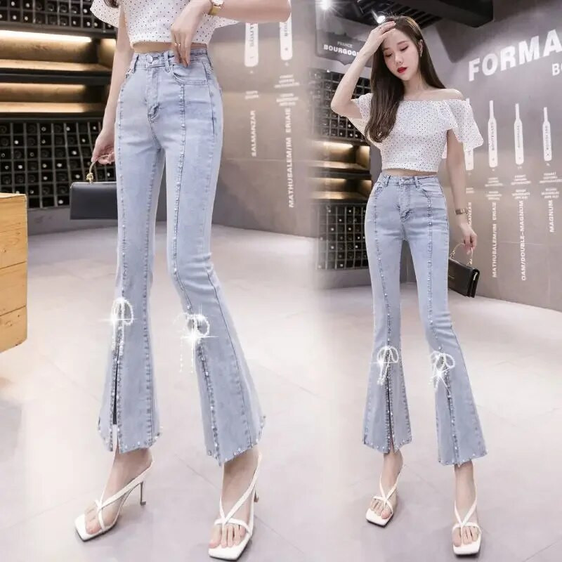 Mood kõrge vöökohaga teksad, naine, vabaaja tänavarõivad, küünehelmed, teksariidest püksid, naised, tüdrukud, vanad, liibuvad, poolitatud ääristega püksid.