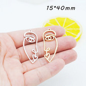 20 tk / partii uus saabumine kullavärvi õõnes abstraktne näo võlu ripatsid tsingi sulamist metallist amulettid ehete valmistamiseks 15 * 40 mm