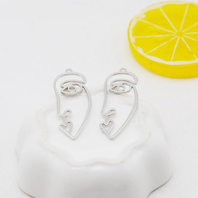 20 tk / partii uus saabumine kullavärvi õõnes abstraktne näo võlu ripatsid tsingi sulamist metallist amulettid ehete valmistamiseks 15 * 40 mm