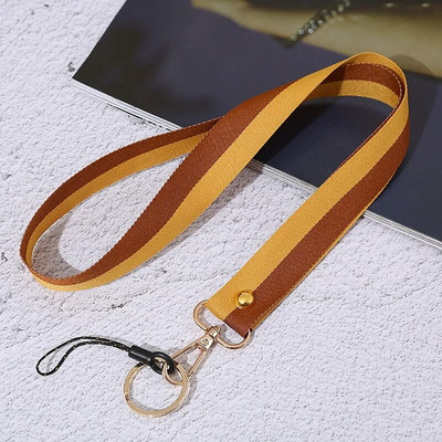 Divu krāsu tālruņa auklas plaukstas siksniņa Virve apaļš kulons Pretnozaudēšanas auklas rokassprādze Mobilā tālruņa futrālis Sling pārnēsājams atslēgu piekariņš