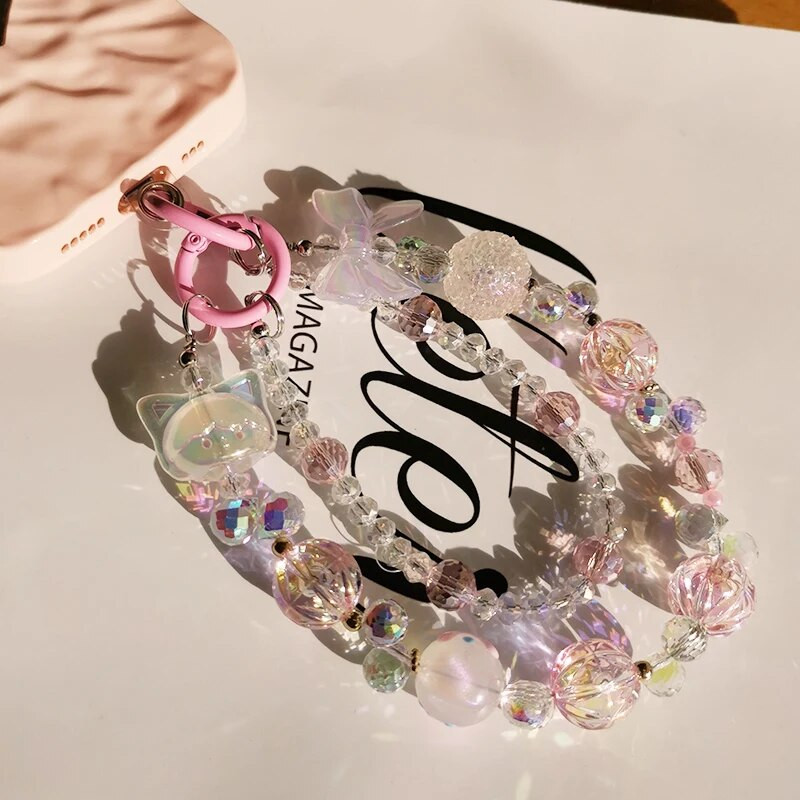 Īsas kristāla pērlītes Mazas meitenes plaukstas locītava, piekarināma ķēde mobilā tālruņa auklas stiprinājuma stils, dubultā ķēdes tālruņa futrālis pret zudumu