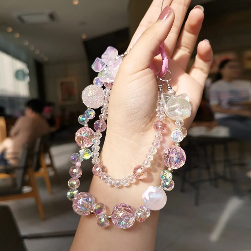 Īsas kristāla pērlītes Mazas meitenes plaukstas locītava, piekarināma ķēde mobilā tālruņa auklas stiprinājuma stils, dubultā ķēdes tālruņa futrālis pret zudumu