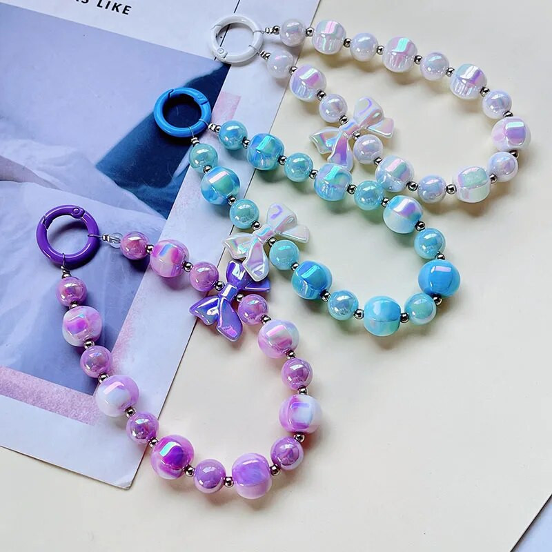 Radoša roku darbs ar pērlītēm mobilā tālruņa ķēde Divu krāsu žilbinoša Bowknot Pērlīšu rokassprādze Jauki mugursomas dekori Mobilā tālruņa futrāļa ķēdes