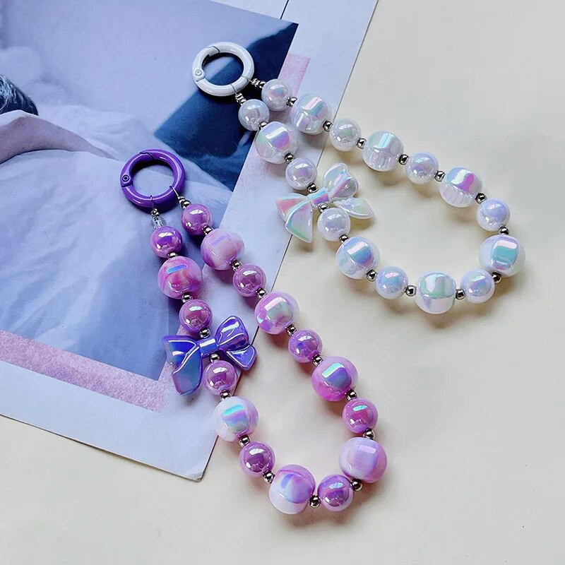 Radoša roku darbs ar pērlītēm mobilā tālruņa ķēde Divu krāsu žilbinoša Bowknot Pērlīšu rokassprādze Jauki mugursomas dekori Mobilā tālruņa futrāļa ķēdes