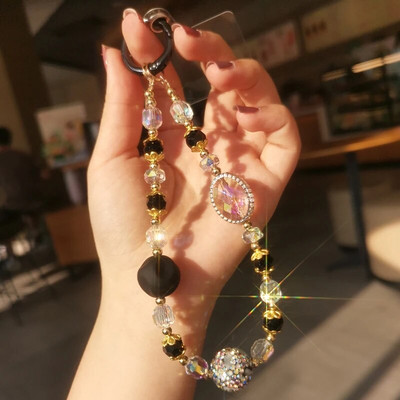 Mobilā tālruņa auklas īsa krāsaina dimanta dārgakmeņu plaukstas rokassprādze ar pilnu dimanta melna zelta kristāla pērlītēm pret zudumiem