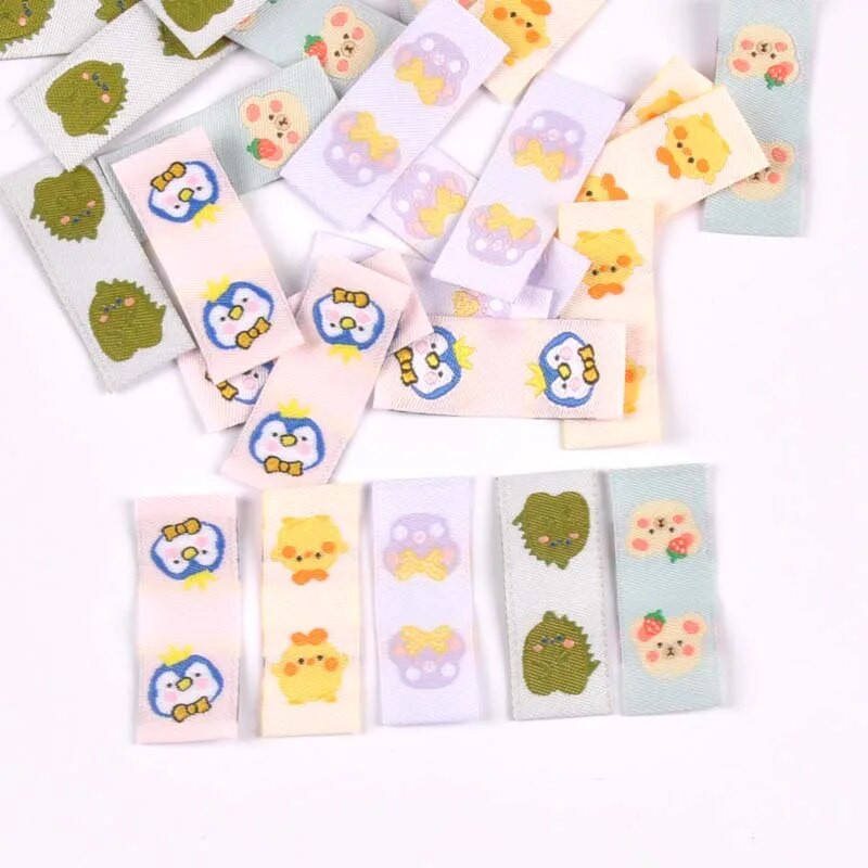 50Gb Karikatūras Dinozauru/Pingvīnu Etiķetes Apaviem Kopšanas somām Šūšana Apģērbs Roku darbs Piederumi DIY Amatniecība Audums Apģērbu Birkas