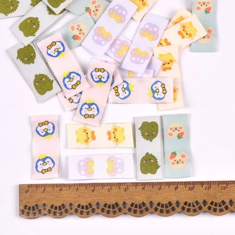 50Gb Karikatūras Dinozauru/Pingvīnu Etiķetes Apaviem Kopšanas somām Šūšana Apģērbs Roku darbs Piederumi DIY Amatniecība Audums Apģērbu Birkas