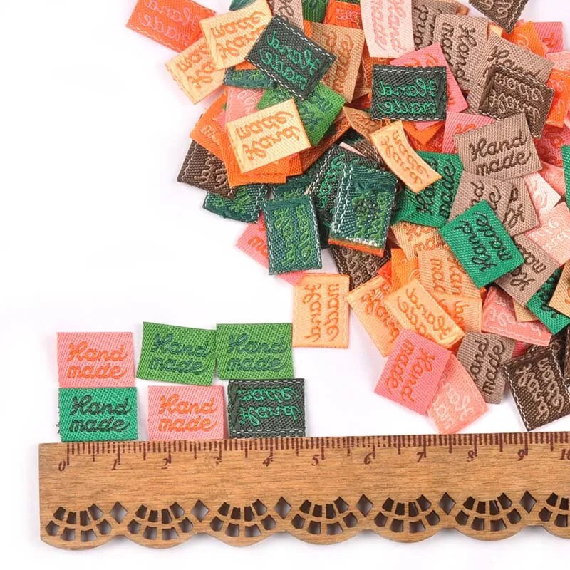 100 tk/kott Tikitud riidest sildid DIY rõivakotid rõivaste jaoks Reljeefse lipuga õmblussildid Käsitsi valmistatud tarvikud 11x15 mm C2393