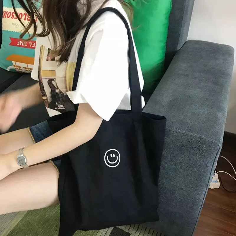 Naiste lõuendist õlakott naeratava näoprindiga Naiste vabaaja käekott Kandekott Suure mahutavusega puuvillane korduvkasutatav ostukott