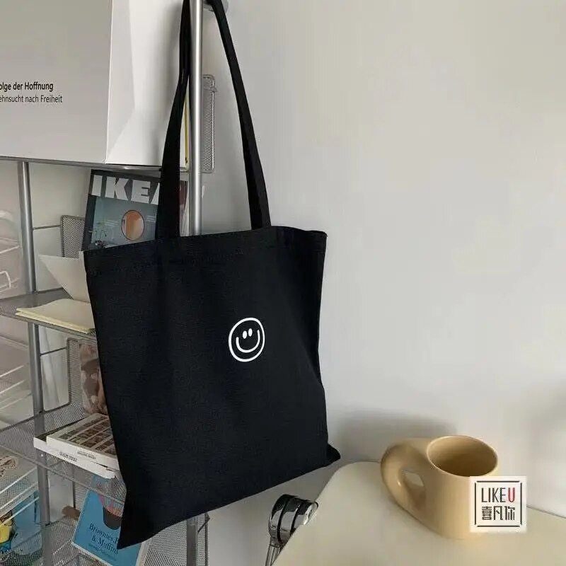 Naiste lõuendist õlakott naeratava näoprindiga Naiste vabaaja käekott Kandekott Suure mahutavusega puuvillane korduvkasutatav ostukott