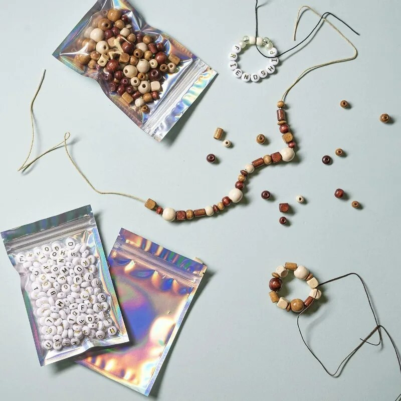 Taassuletavad lasertõmblukuga kotid väikeettevõtete pakendid holograafilised ümbrikud lamedad läbipaistvad plastikust kommid ehted toidu säilituskott