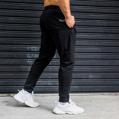 Elasticitate Pantaloni de alergare pentru bărbați Pantaloni de sport casual cu buzunare cu fermoar Antrenament Jogging Pantaloni de fitness Pantaloni de sport pentru antrenament de sală