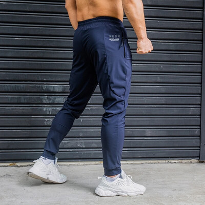 Elasticitate Pantaloni de alergare pentru bărbați Pantaloni de sport casual cu buzunare cu fermoar Antrenament Jogging Pantaloni de fitness Pantaloni de sport pentru antrenament de sală