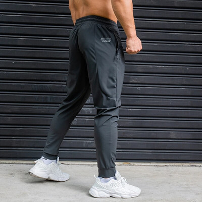 Elasticitate Pantaloni de alergare pentru bărbați Pantaloni de sport casual cu buzunare cu fermoar Antrenament Jogging Pantaloni de fitness Pantaloni de sport pentru antrenament de sală