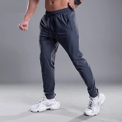 Pantaloni pentru bărbați cu uscare rapidă Pantaloni sport pentru alergare cu buzunare cu fermoar Pantaloni de antrenament pentru jogging Pantaloni casual de fitness