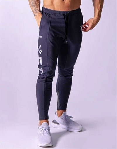 Pantaloni de fitness pentru bărbați de primăvară și toamnă Pantaloni casual sport Pantaloni lungi Pantaloni în nouă puncte de culoare uni Pantaloni largi pentru alergare
