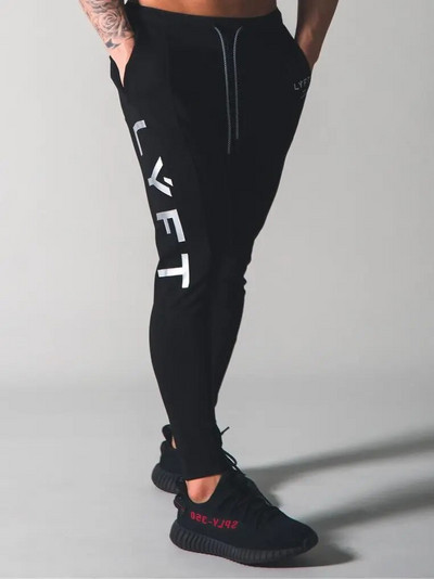 Pantaloni de fitness pentru bărbați de primăvară și toamnă Pantaloni casual sport Pantaloni lungi Pantaloni în nouă puncte de culoare uni Pantaloni largi pentru alergare