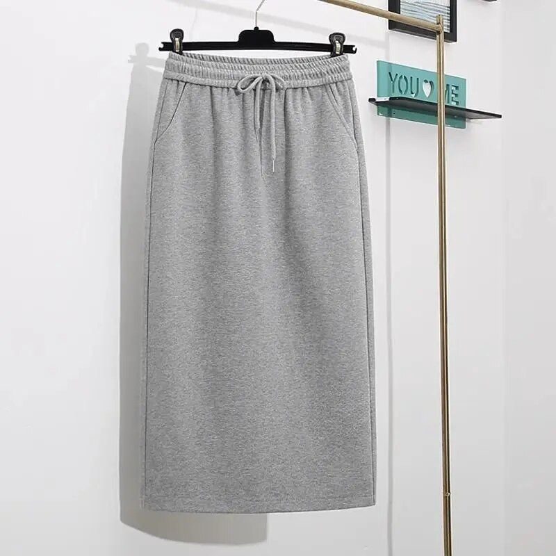 Proljeće i jesen 2023. Jednostavna i moderna svestrana uska ravna polusuknja visokog struka s džepovima na vezanje i pokriva međunožje