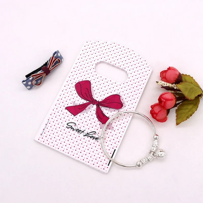 50 db/tétel Multi Designs Kis műanyag zacskó 9x15cm Boutique Ajándéktáska Fogantyúval Szép Charms Fülbevaló Ékszer Csomagoló Táskák