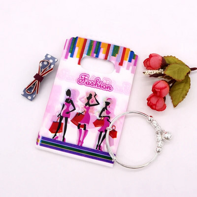 50 db/tétel Multi Designs Kis műanyag zacskó 9x15cm Boutique Ajándéktáska Fogantyúval Szép Charms Fülbevaló Ékszer Csomagoló Táskák