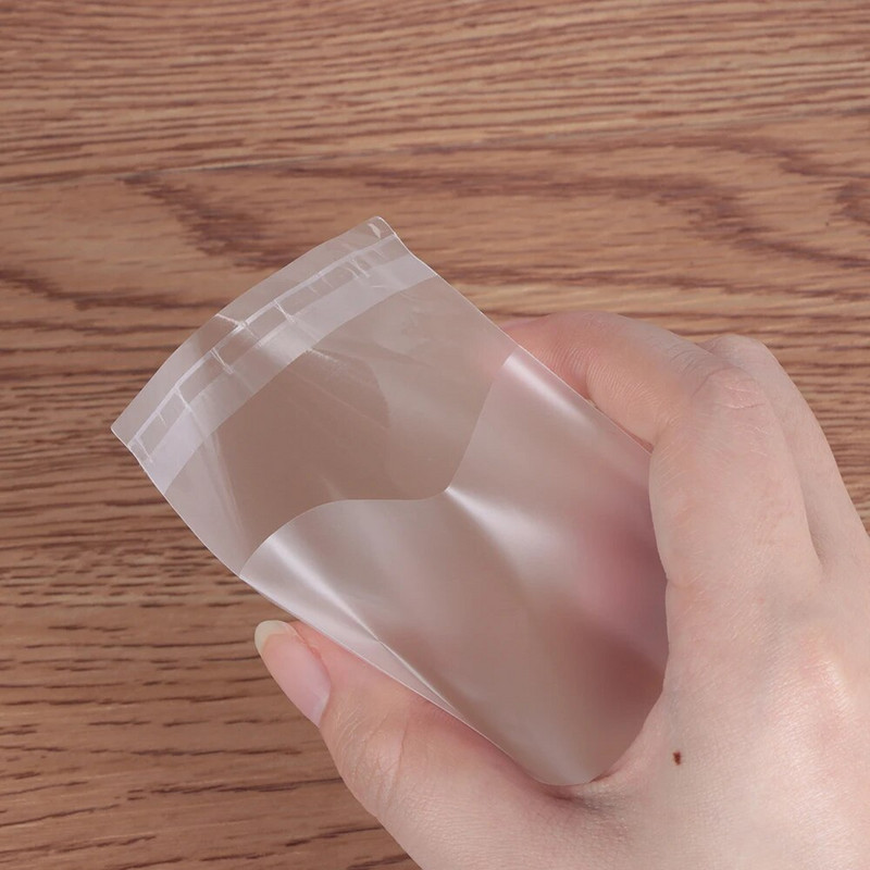 100 tk. Läbipaistev jäätunud kommide küpsiste kinkekott ise isekleepuva kotiga Pulma sünnipäevapeo kommide pakkimiskott