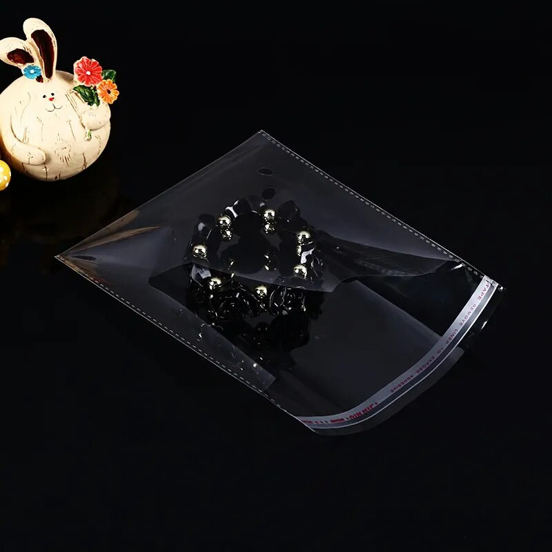 100 gab. Vairāku izmēru caurspīdīgs, pašlīmējošs čella celofāna maisiņš Pašnoblīvējošs mazs plastmasas maisiņš konfekšu iesaiņošanai atkārtoti noslēdzami maisiņi