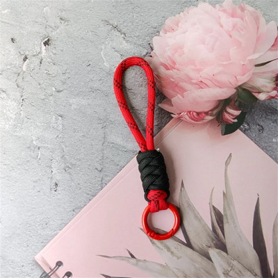 Spalvingas pintas virvelinis raktų pakabukas Unisex apsaugos nuo pametimo riešo dirželis Paracord su raktų pakabuku telefono fotoaparatui U disko buteliuko priedai